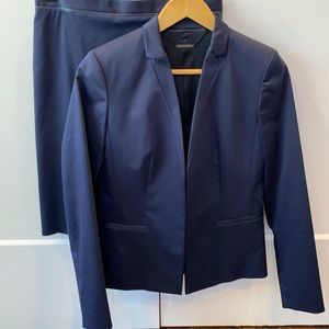 Eli’s Tahari navy suit with faux black leather trim.